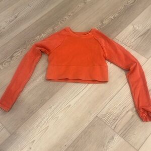 A cute, coral, long-sleeved athletic top